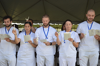 Nursing graduates stand during a Pinning Ceremony