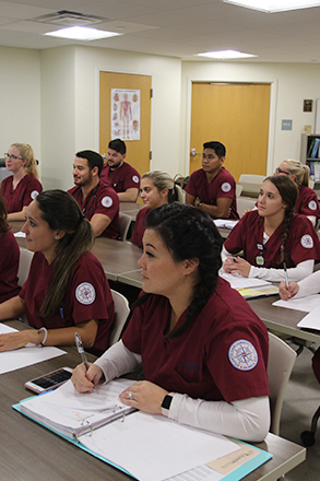 nursing students seated at desks in a classroom