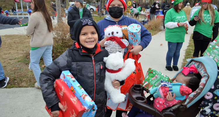Children carry gifts they received during Atlantic Cape's Hope for the Holidays event in Brown's Park in Atlantic City