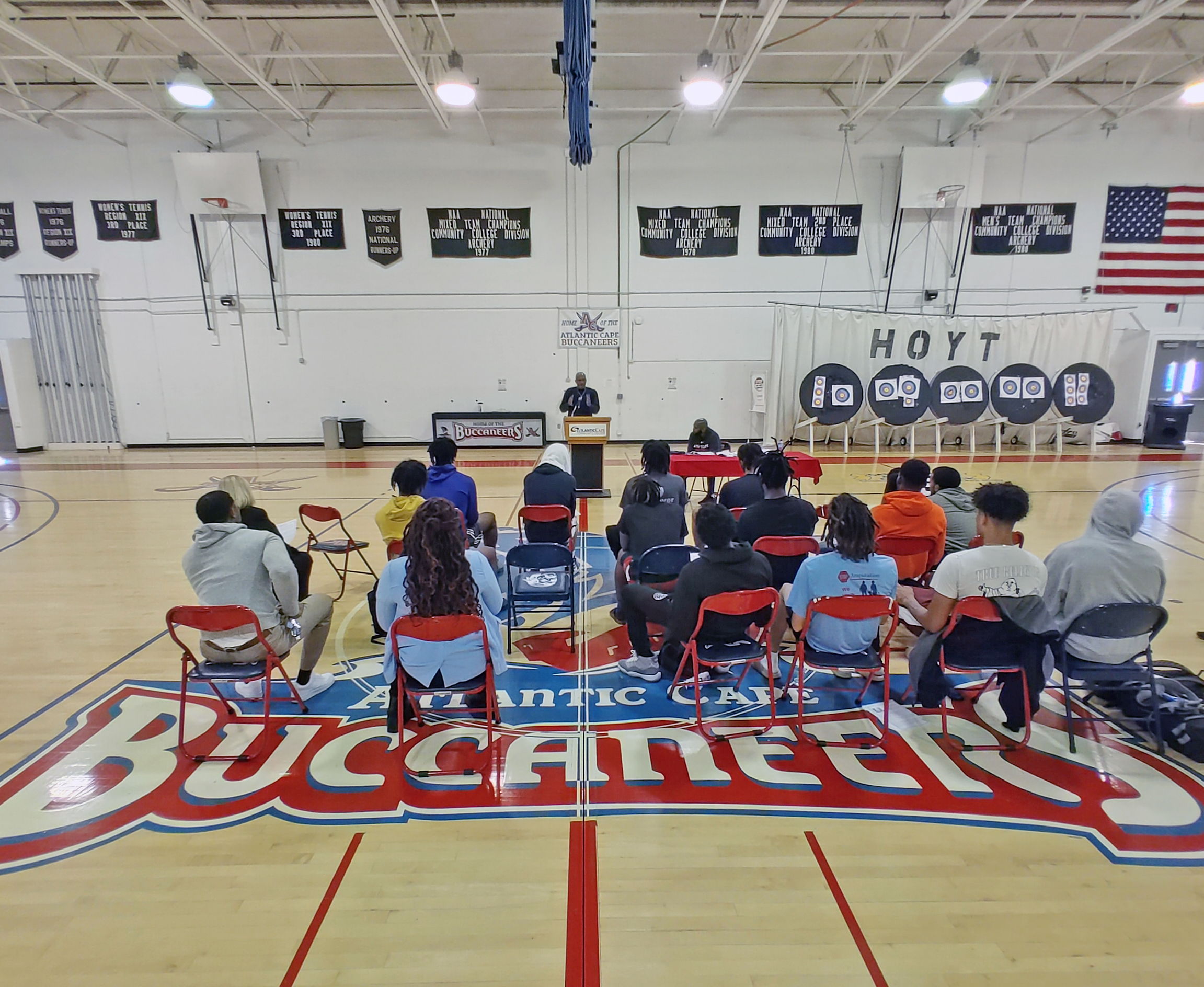 Leonard Hayes speaks with Men's Basketball team