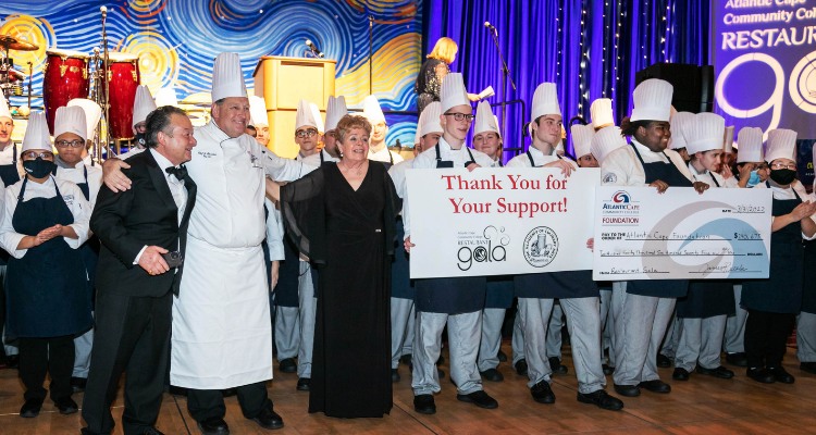 Academy of Culinary Arts students gather on the dance floor to present a check for the funds raised at the 39th Atlantic Cape Restaurant Gala March 31, 2022 at Harrah's in Atlantic City.