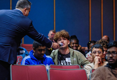 A student asks a question to the panelists