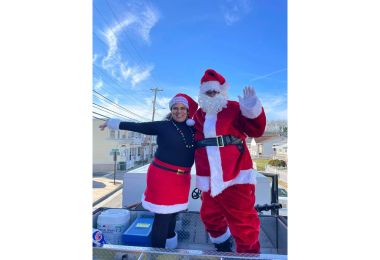 Santa Claus rides atop an Atlantic City fire truck on his way to the Hope for the Holidays event