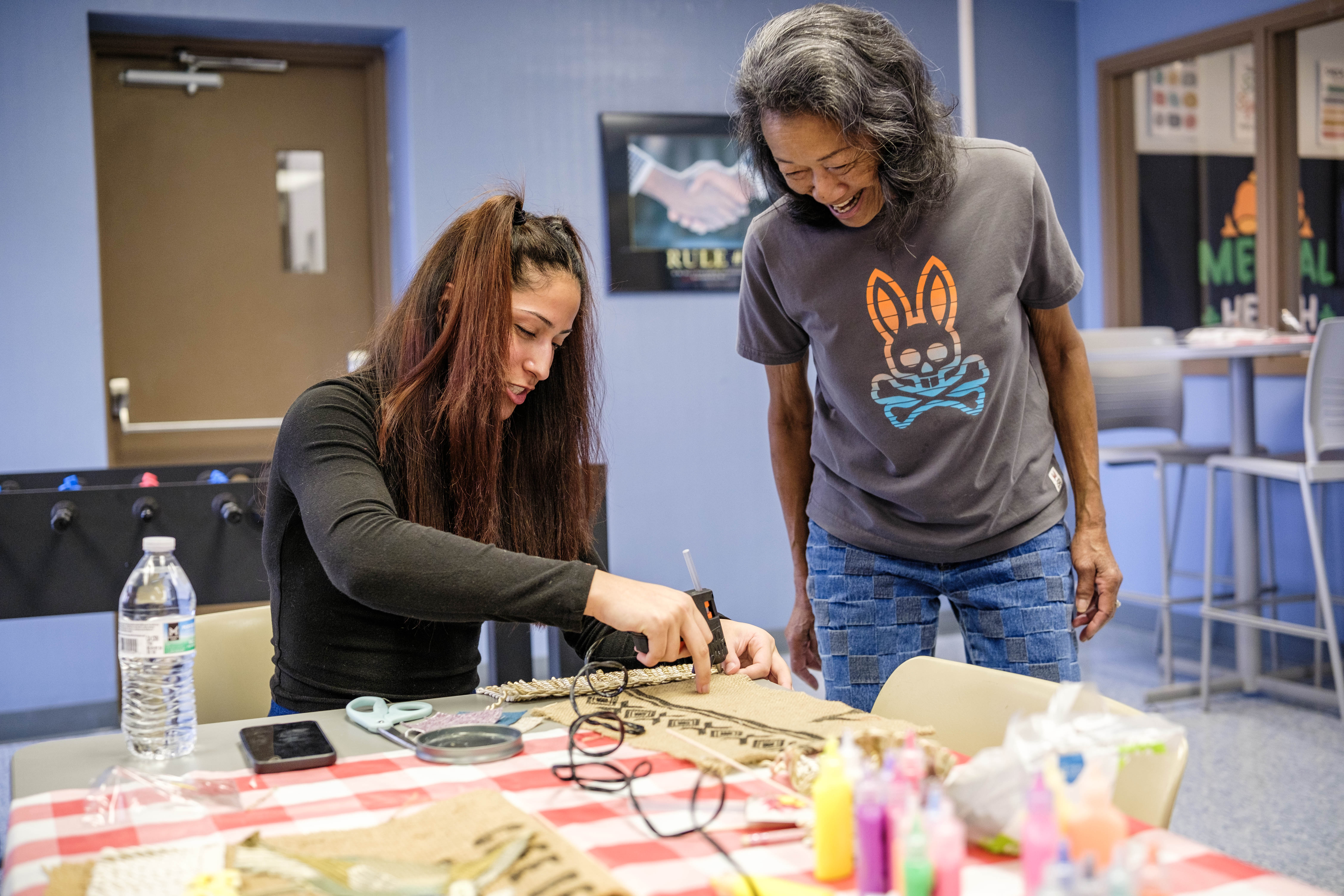 Trice works with a student creating assemblage art