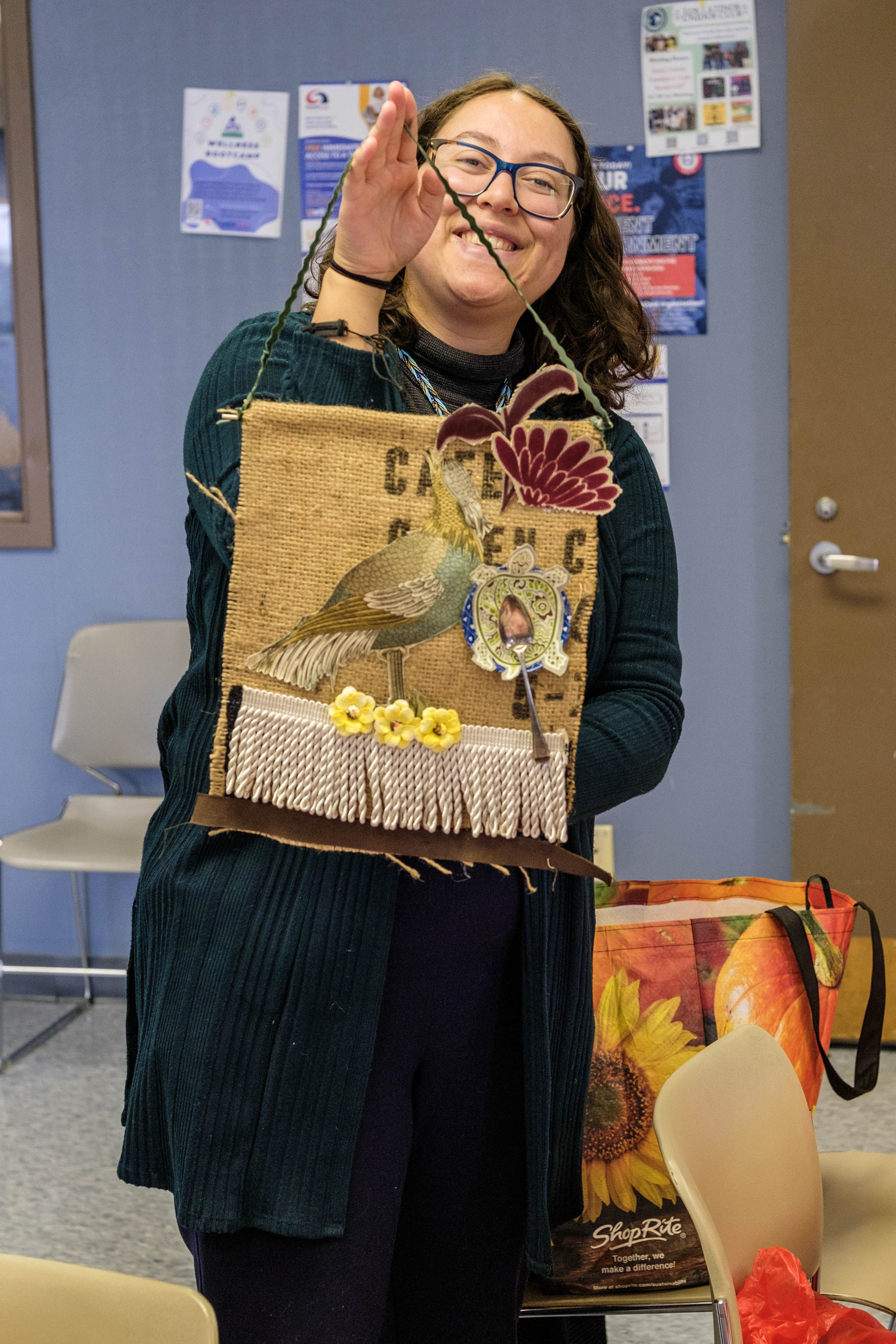 student displays her assemblage art creation