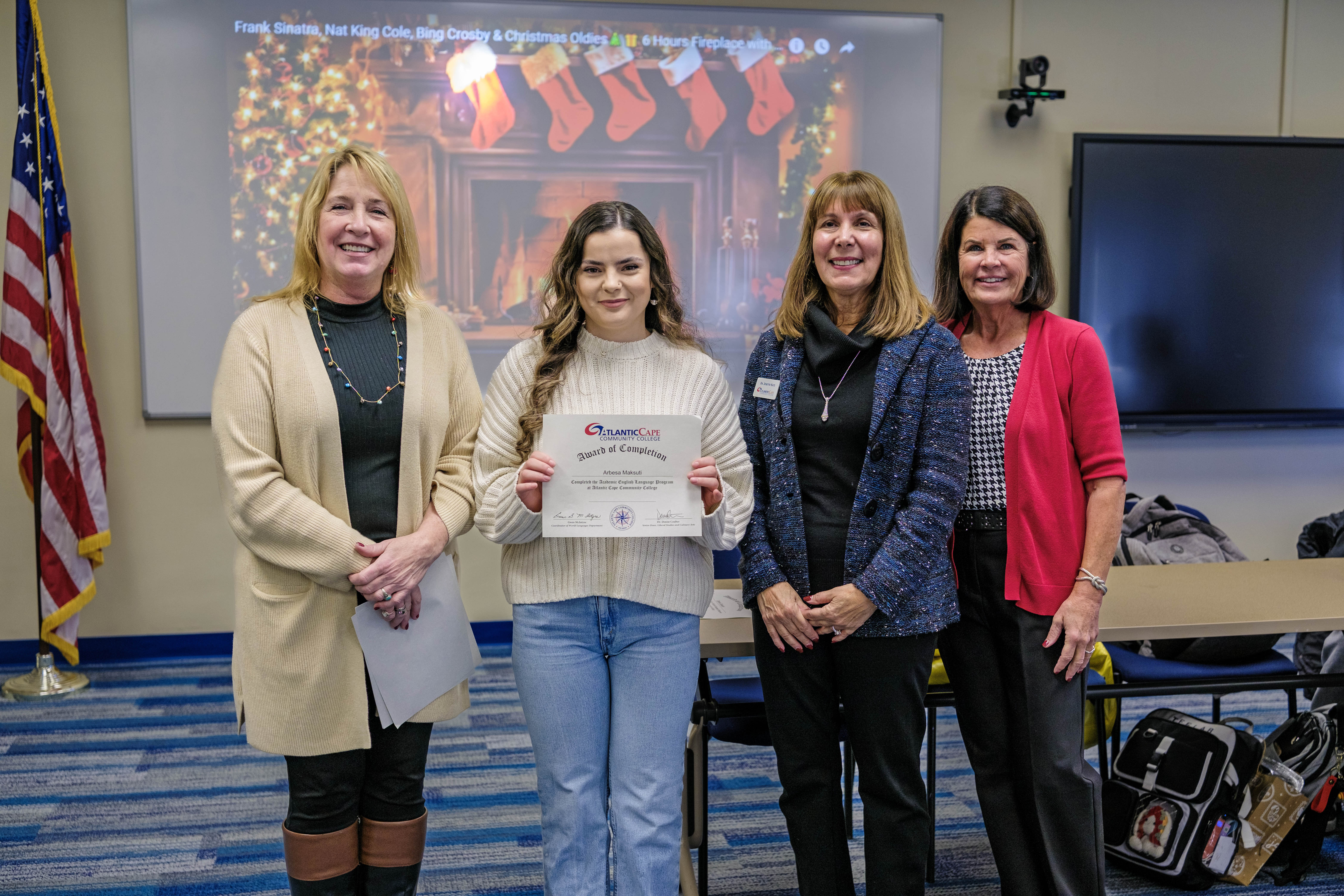 student poses with her certificate of completion