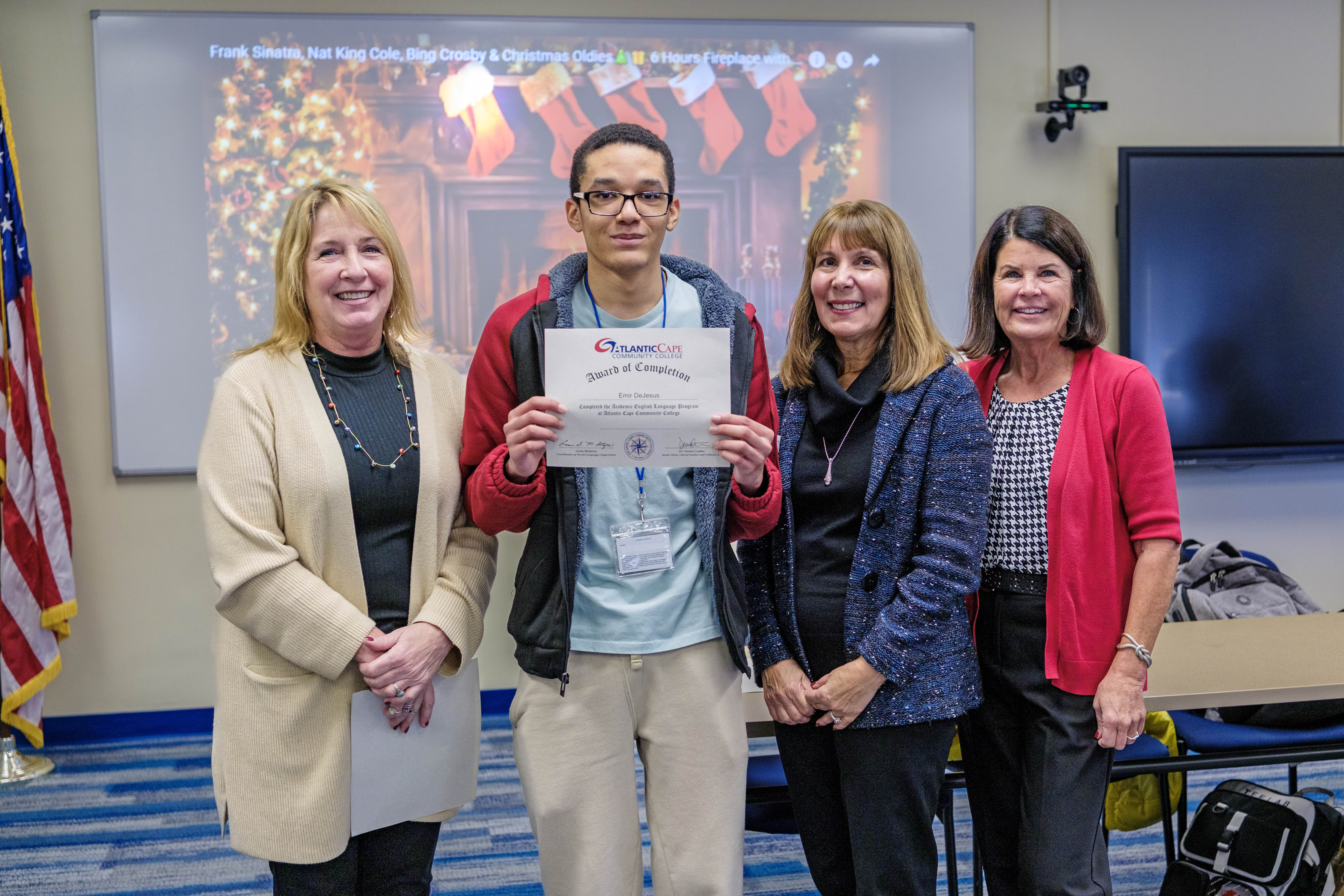 student poses with his certificate