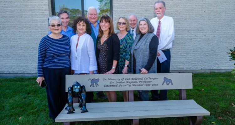 Former colleagues and friends of the late Dr. Louise Kaplan stand behind her memorial bench at Atlantic Cape's Mays Landing Campus