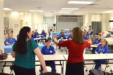 Nursing students in a classroom be instructed by two professors.
