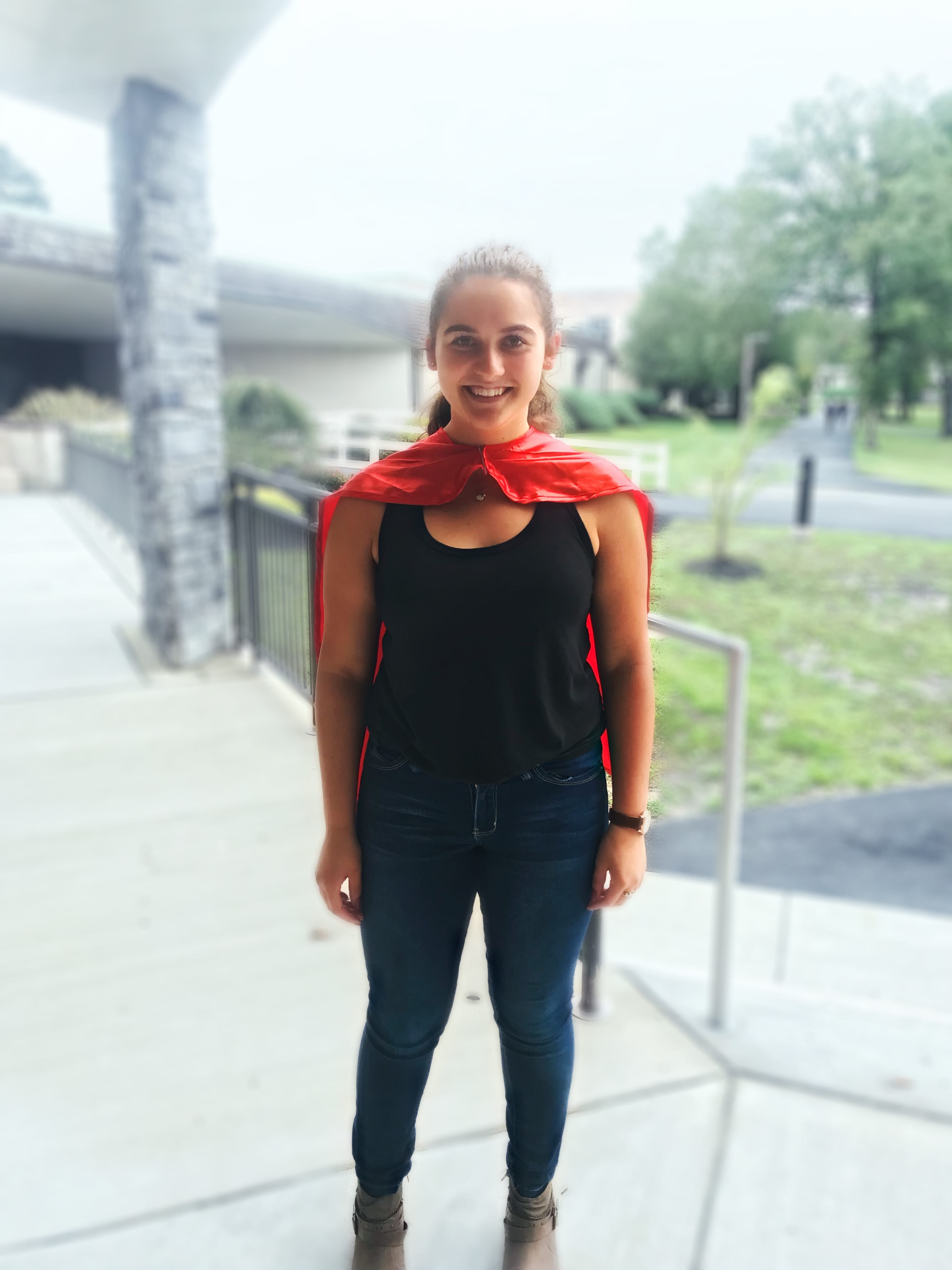 Smiling student wearing cape