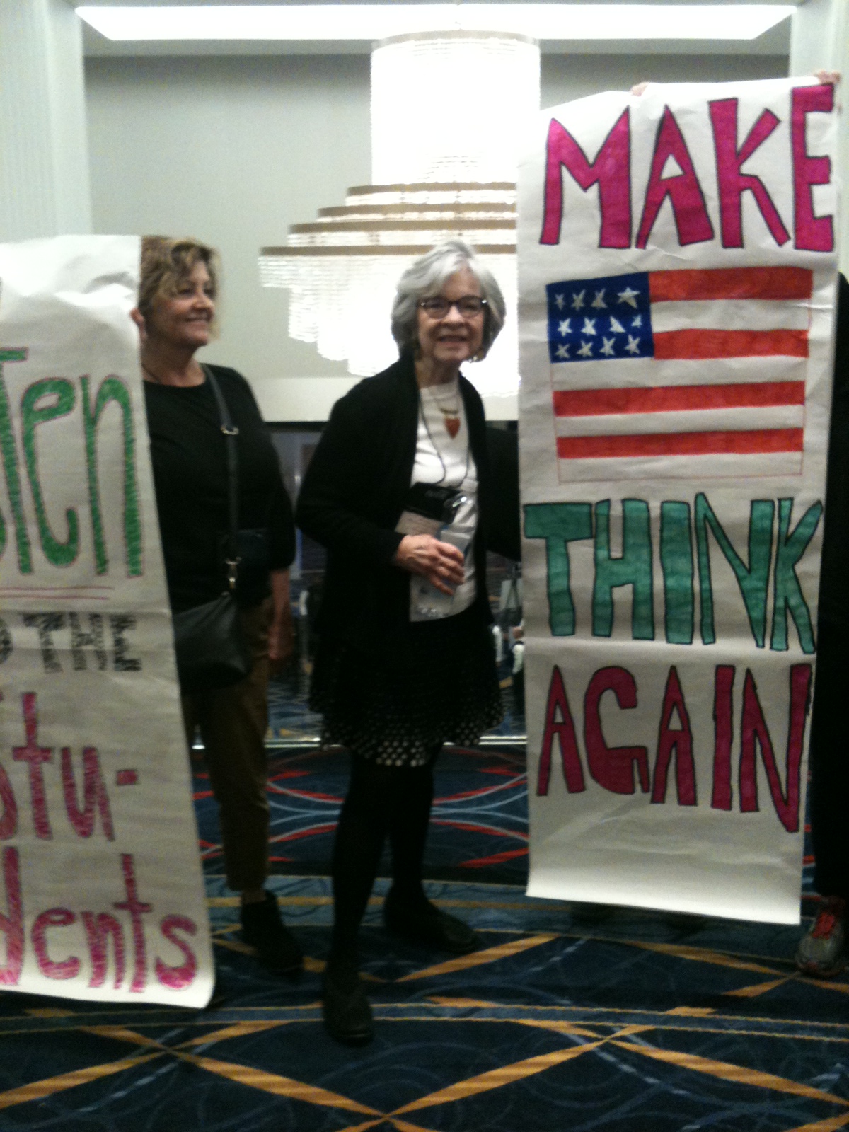 Effie Russell holding a poster that reads "make america think again."