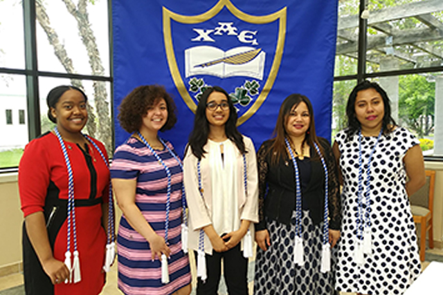 Students in front of their club banner