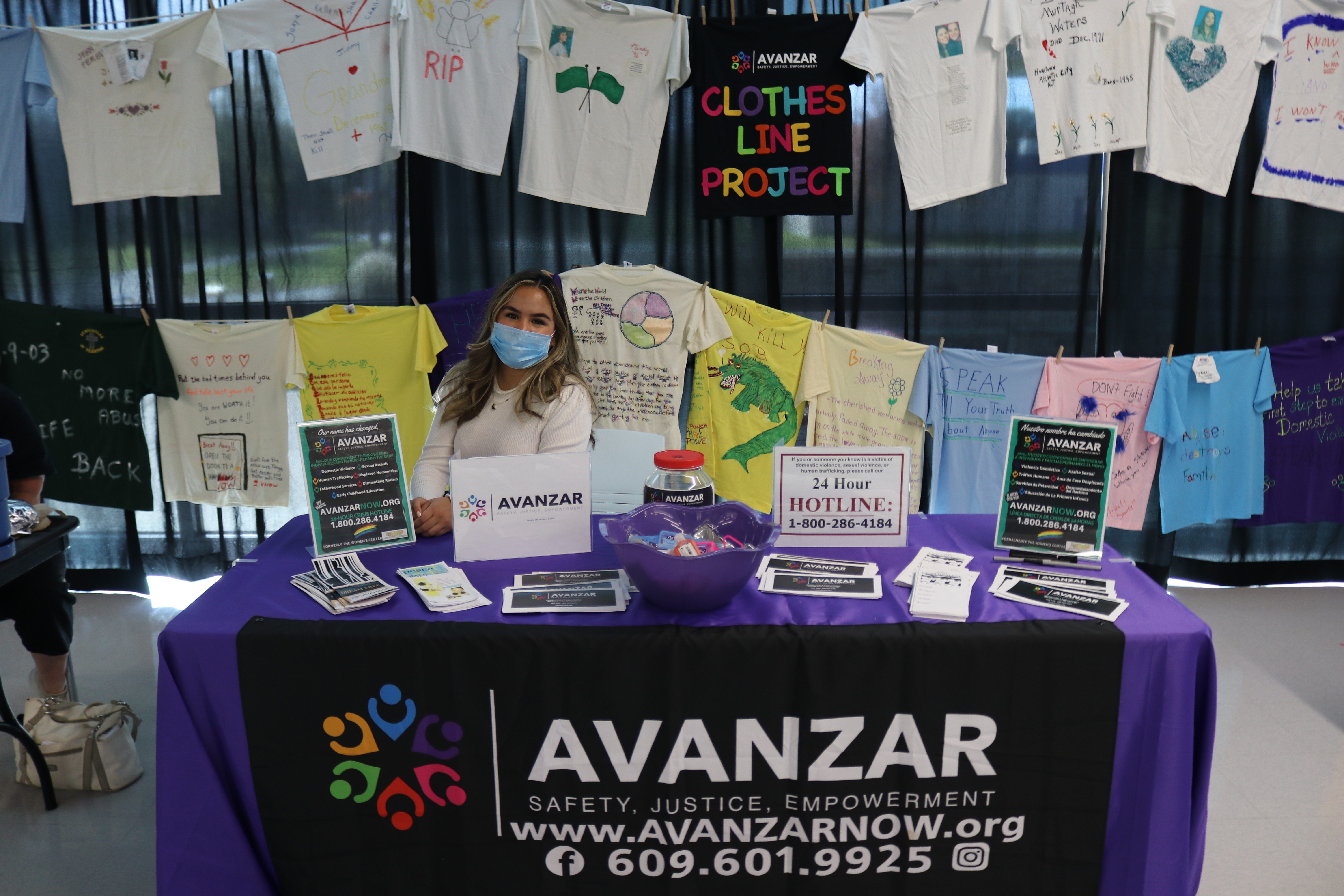 Avanzar table in the student center with The Clothesline Project