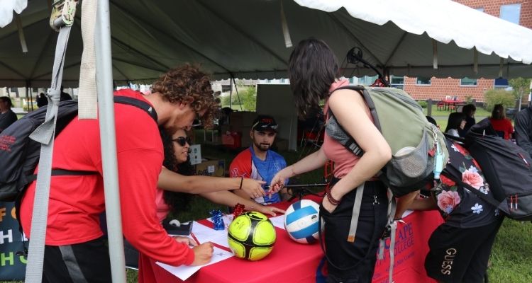 Students learn about new clubs and activities at Wednesday's Welcome Back Picnic.