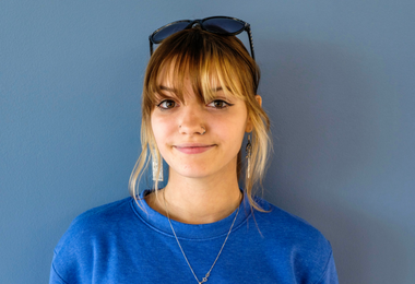 Student wearing blue shirt and smiling