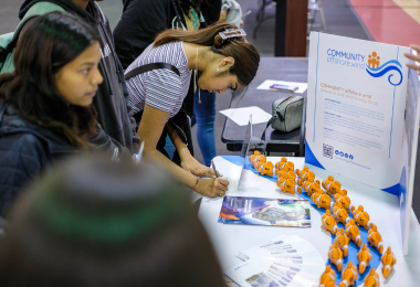 Students filling out information during Junior Achievement Career Fair