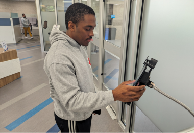 Student signs in on a tablet in the One-Stop Welcome Center