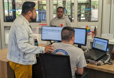 Staff members assisting a student in the One-Stop Welcome Center