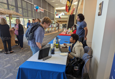 Atlantic Cape student speaks with a college staff member