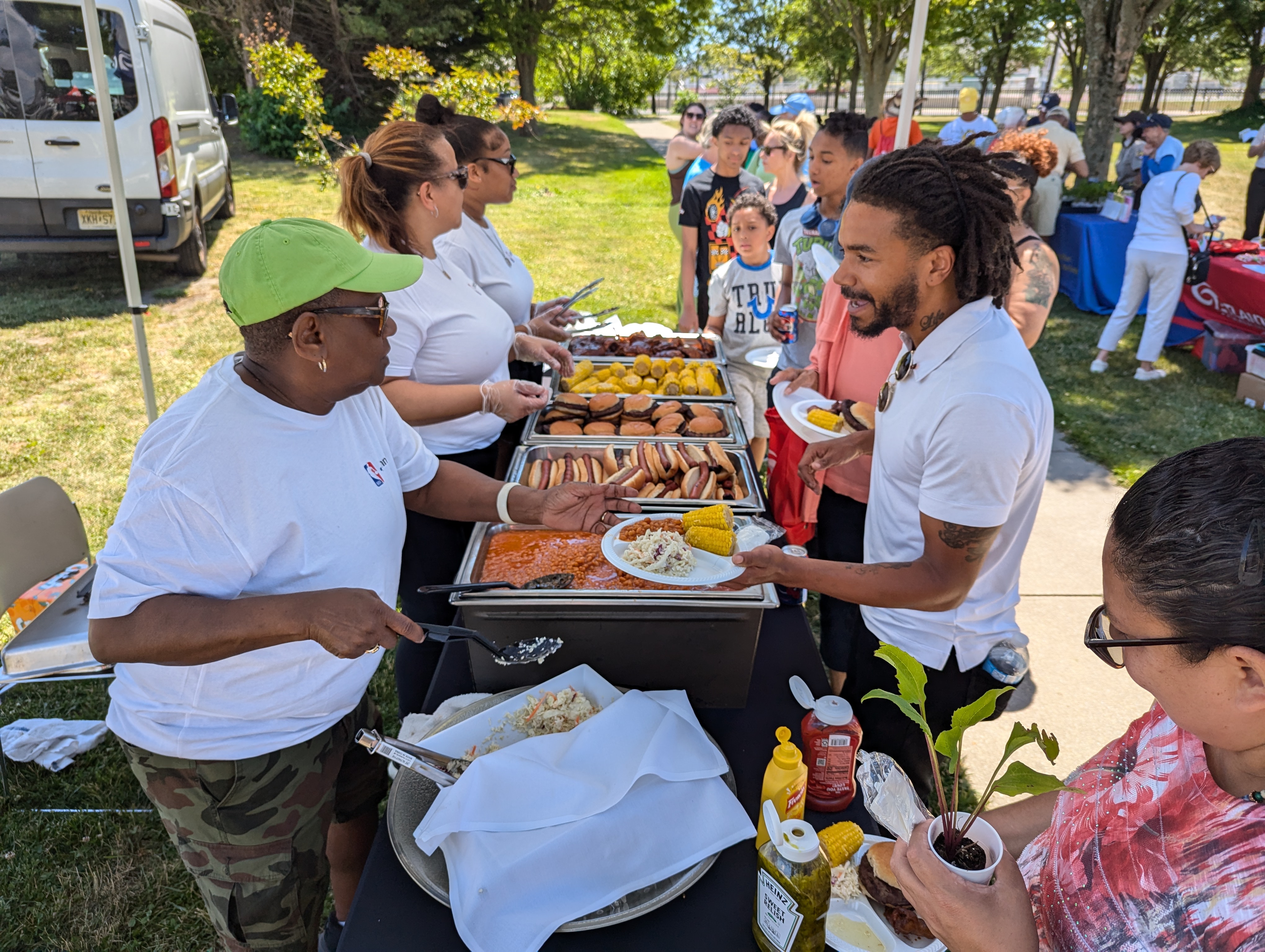 Members of the community enjoy a free lunch at the ribbon cutting ceremony courtesy of Kelsey's