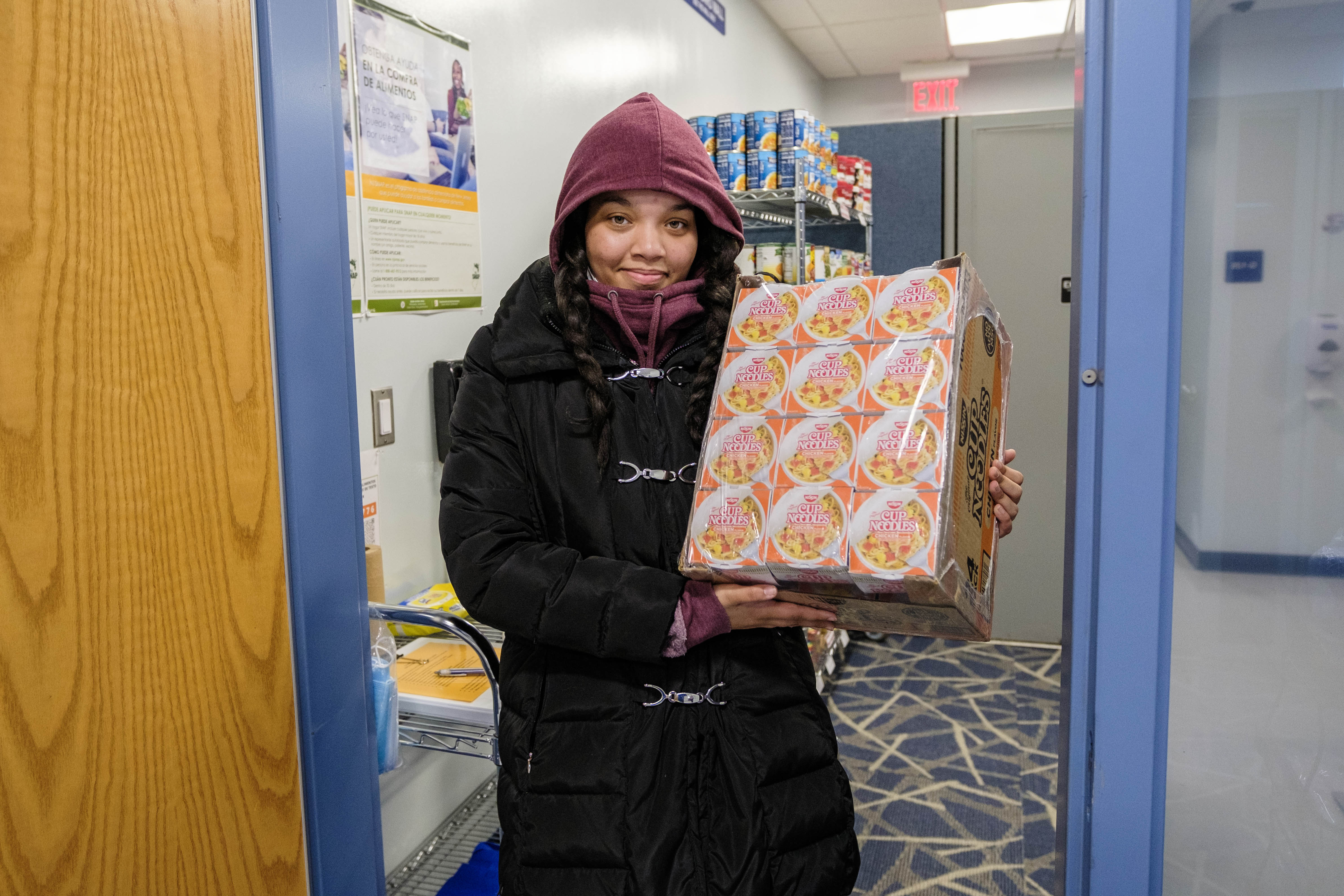 Students hold boxes of soup at Food Pantry