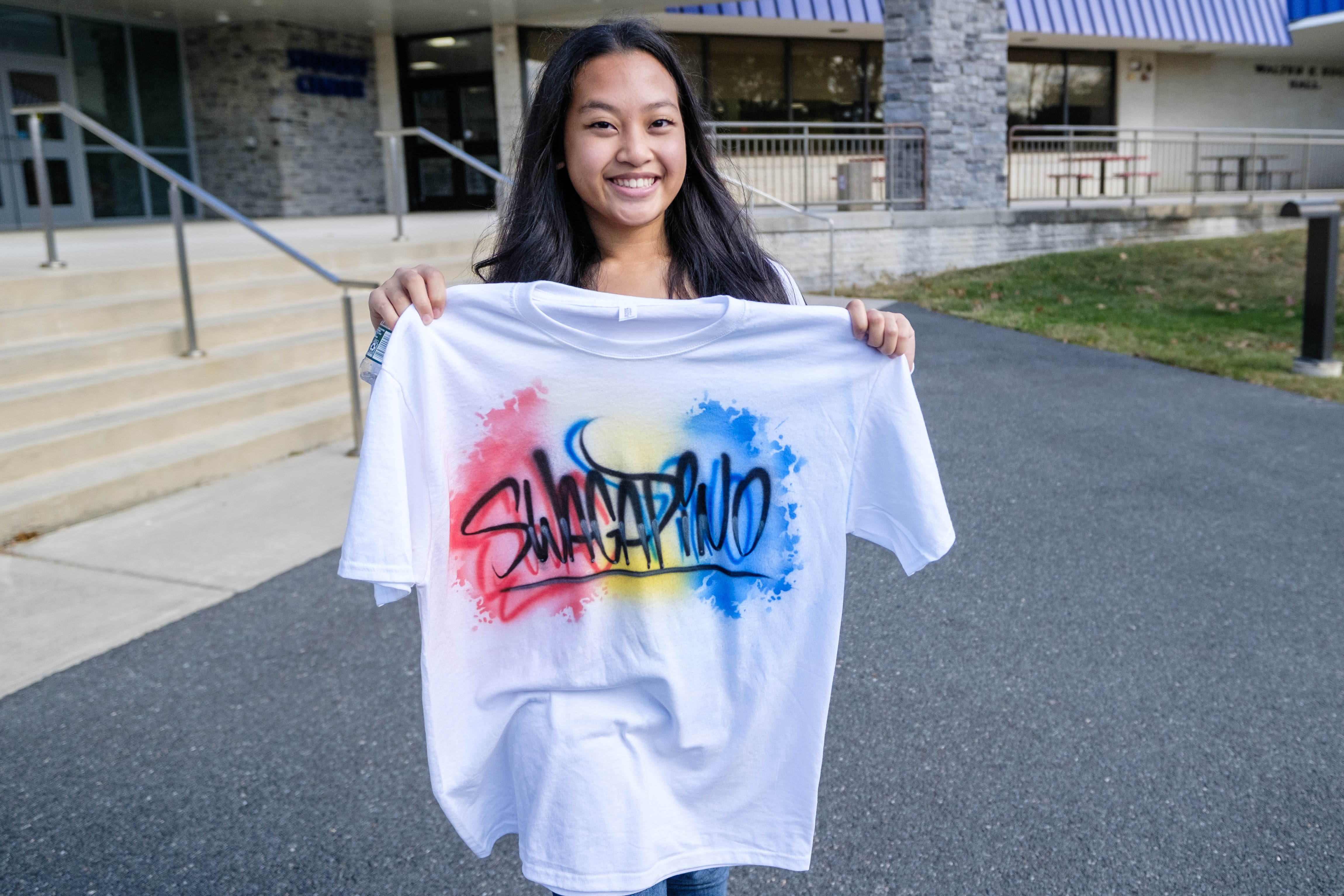 student Rosalie Jongo with her custom spray painted t shirt