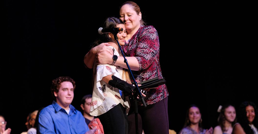 Alejandra Ceballos gets a hug from volleyball coach Karla Maisto at CSS awards