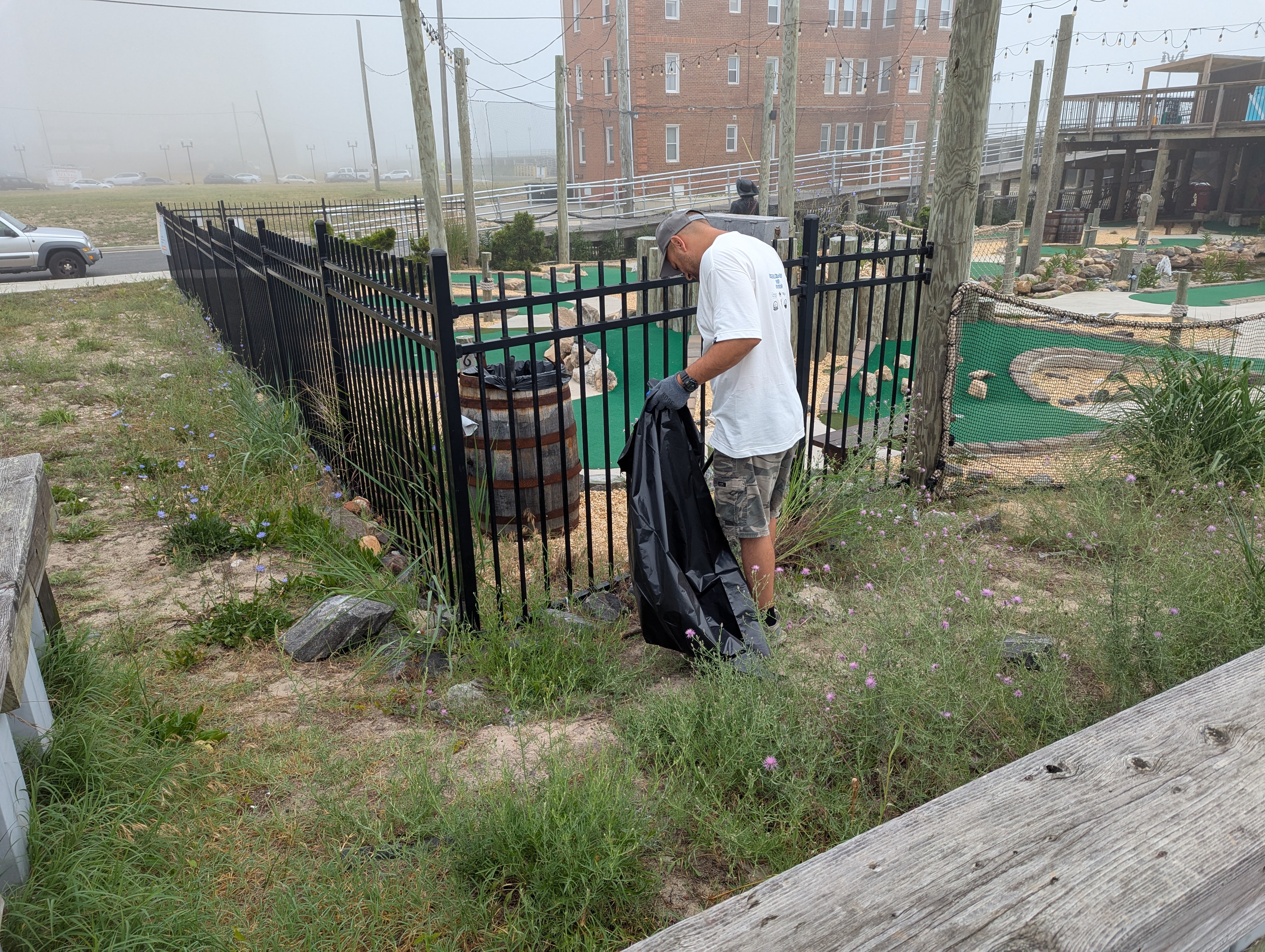 CDC Project Lead Mike Intrieri picking up debris near Atlman Park