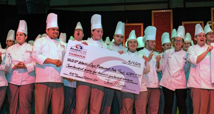 Students from the Academy of Culinary Arts present the Restaurant Gala check donation